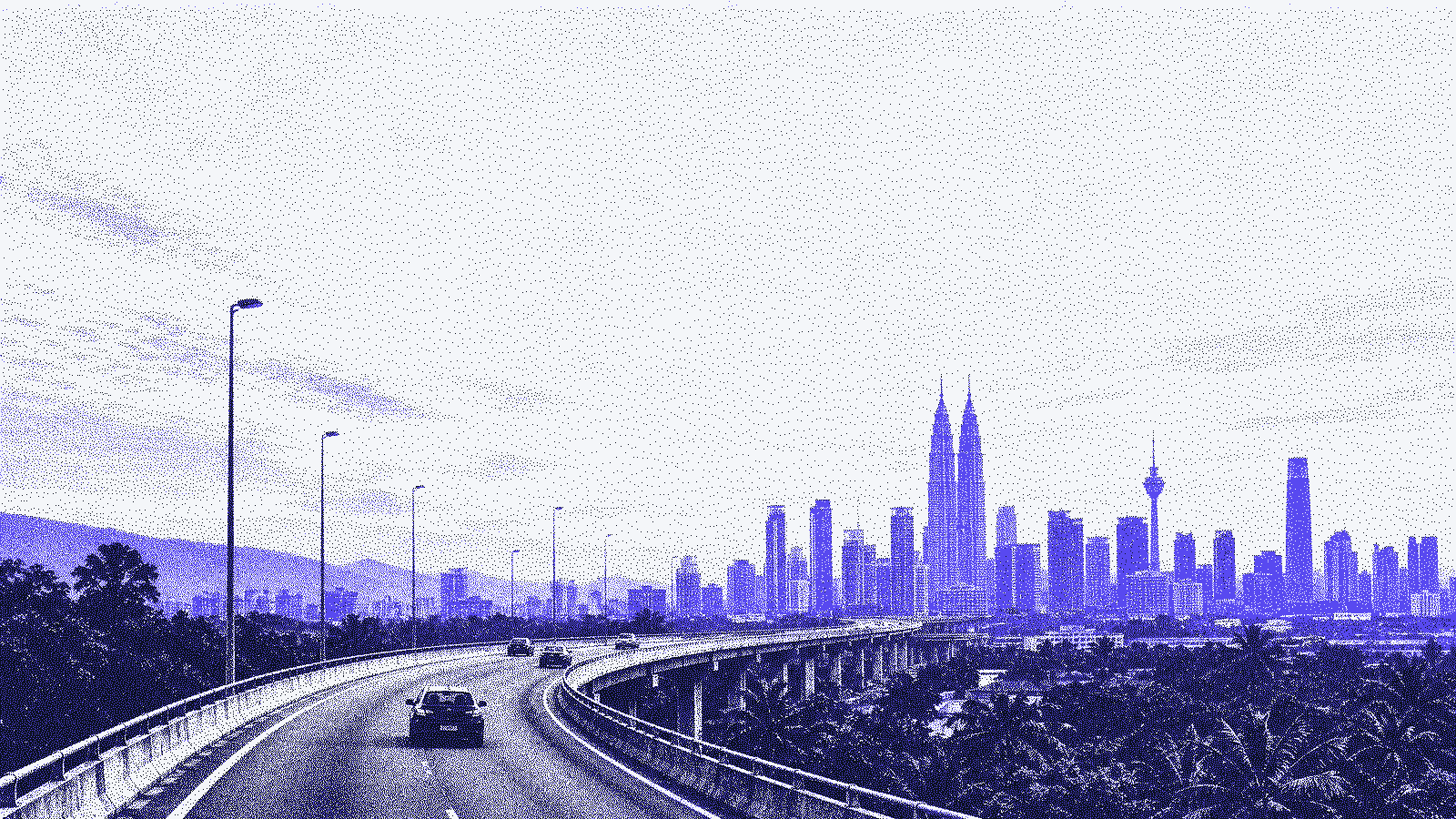 Elevated highway curving toward the city at dawn