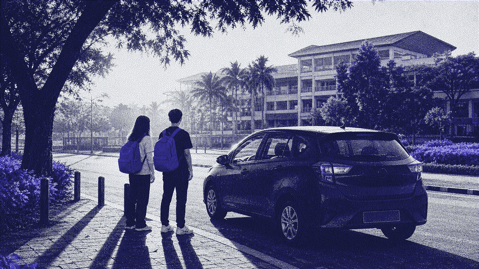 Students waiting with backpacks beside a parked car at a fixed campus pickup point